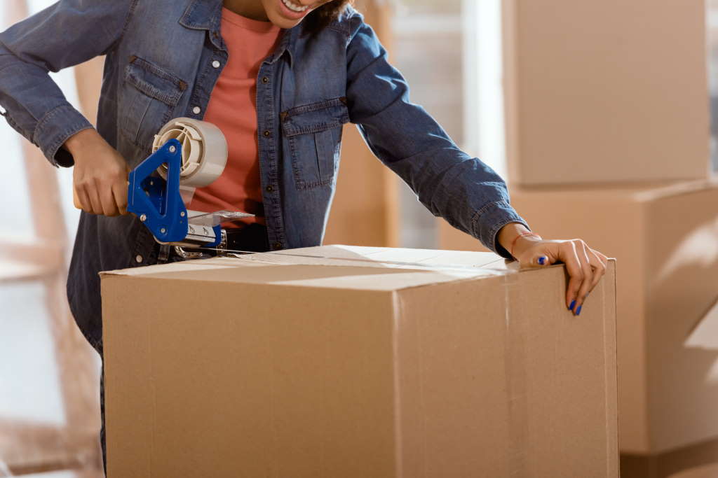 person taping a box